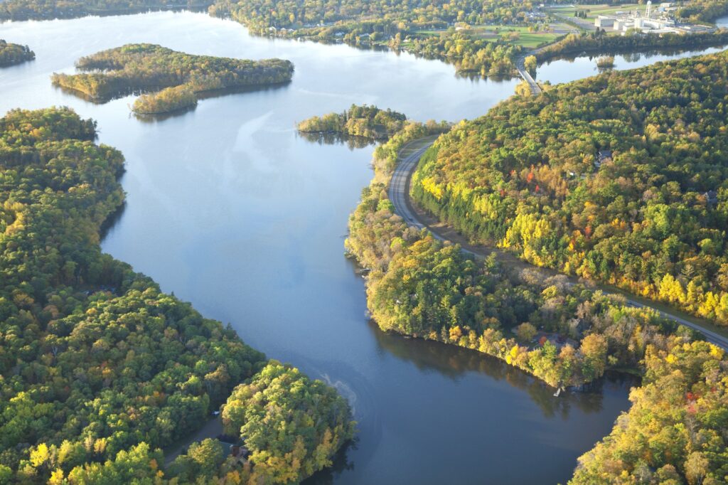 Aerial view of curving road along Mississippi River during autumn